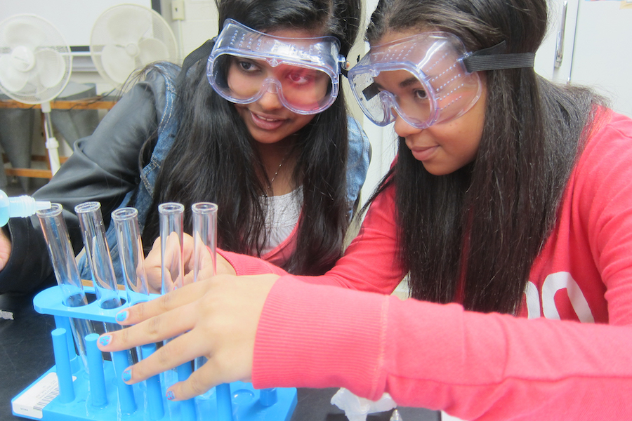 two girls in science lab conducting experiment