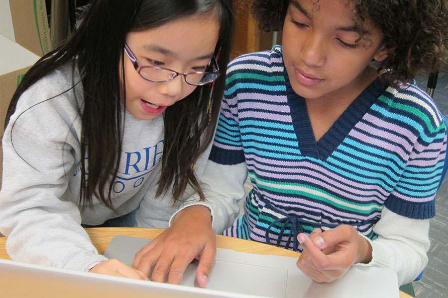 two elementary students working on a computer