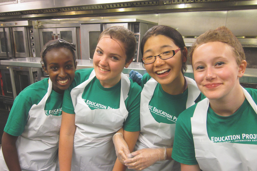 three girls in apron at kitchen