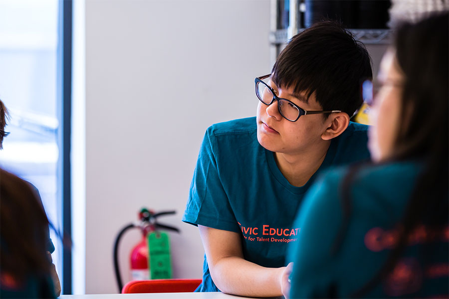 boy at table listening to community partner