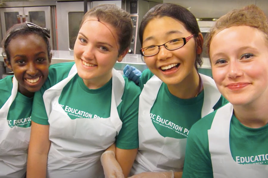 four high school girls preparing food