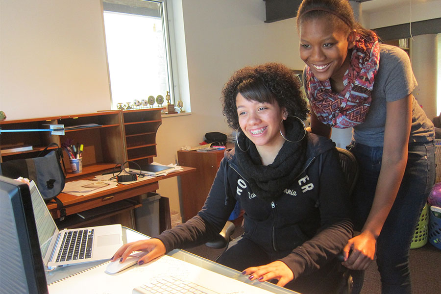 two high school girls working online together