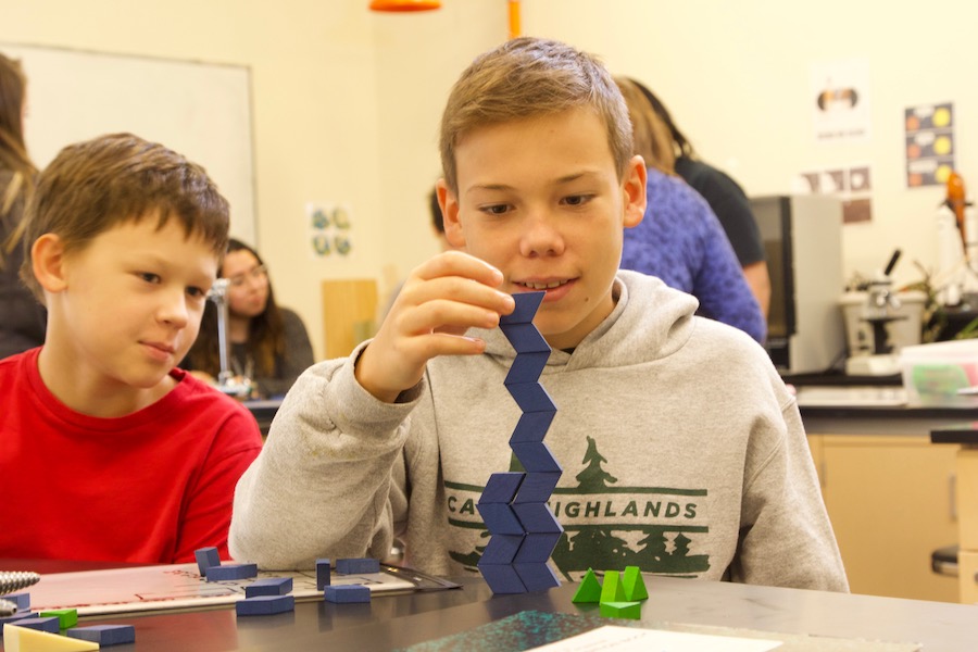 two middle school boys building with tangrams