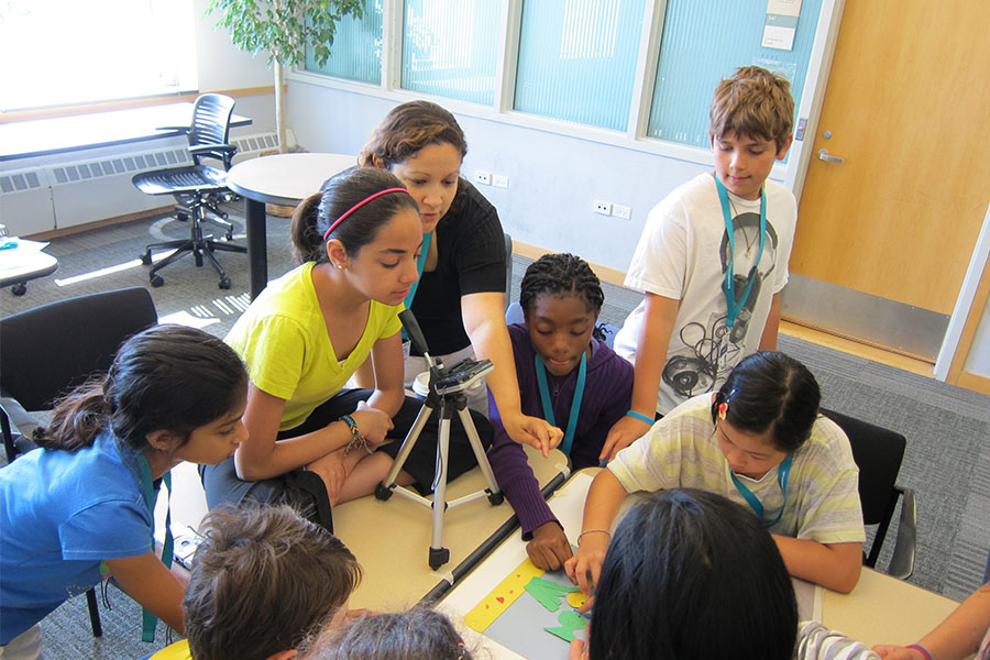 middle school students in classroom working with cameras