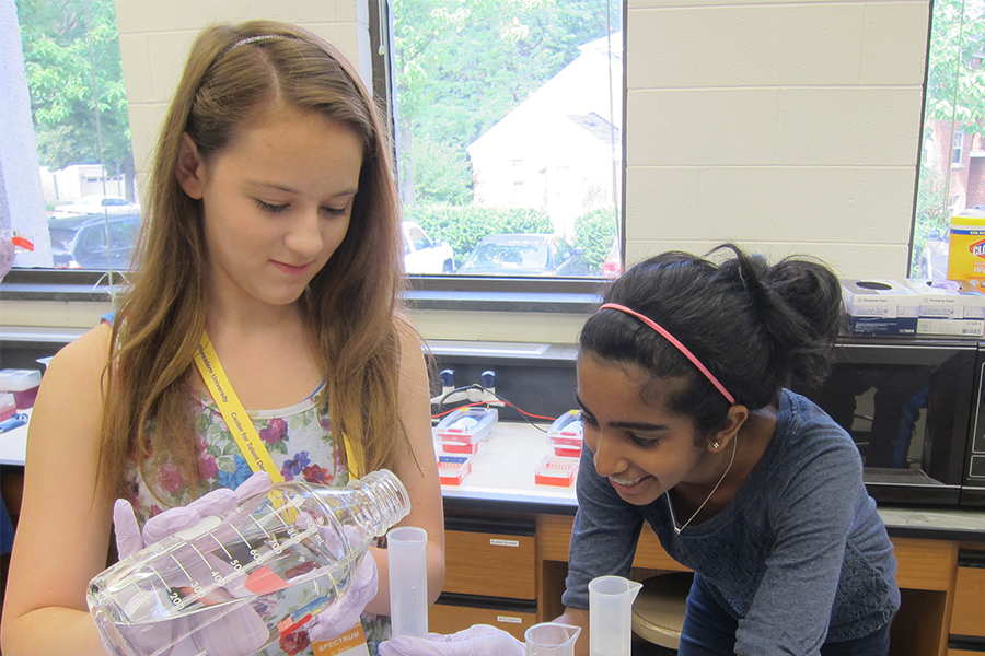 two girls in classroom working on collaborative project