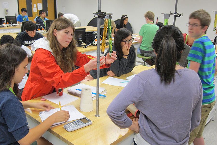 high school students at lab table doing experiment