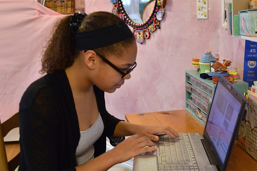 high school girl working on school work at home