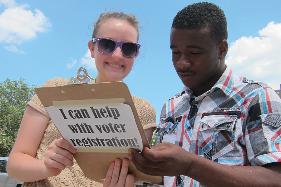 boy and girl holding clipboard for voter registration