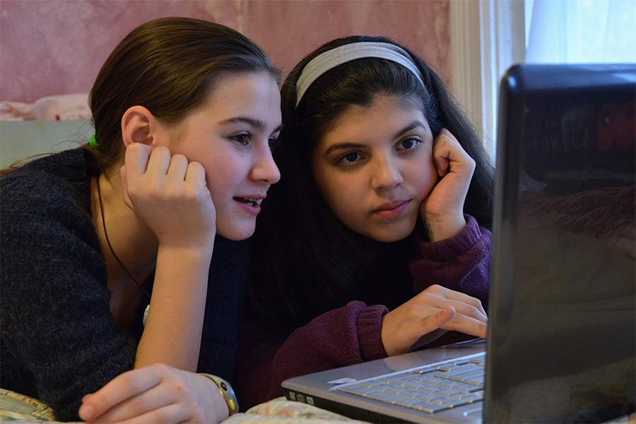 two middle school girls working on computer