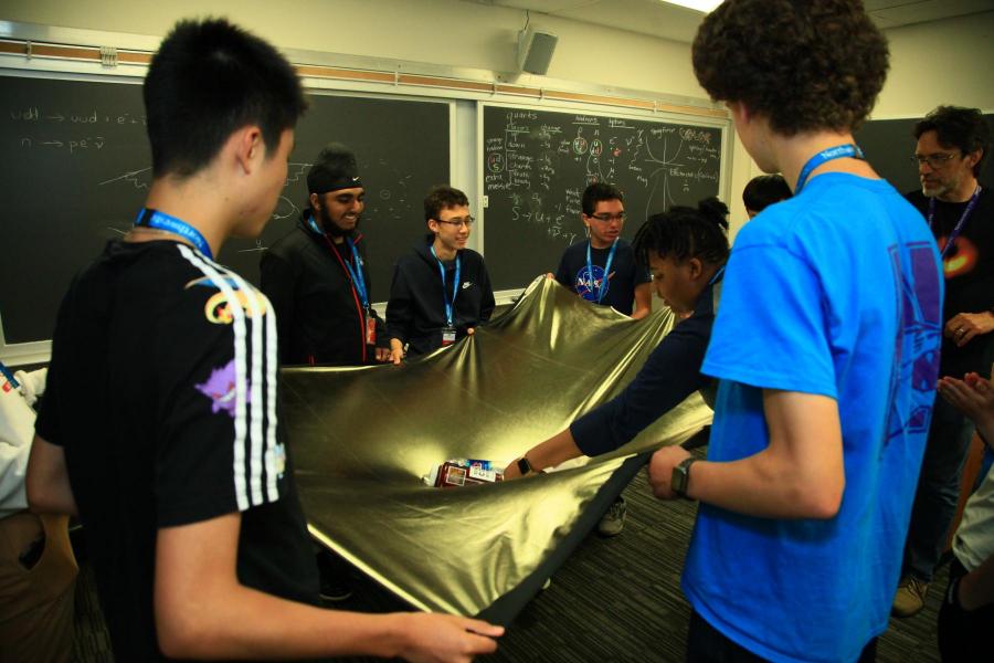 high school students conducting a physics experiment
