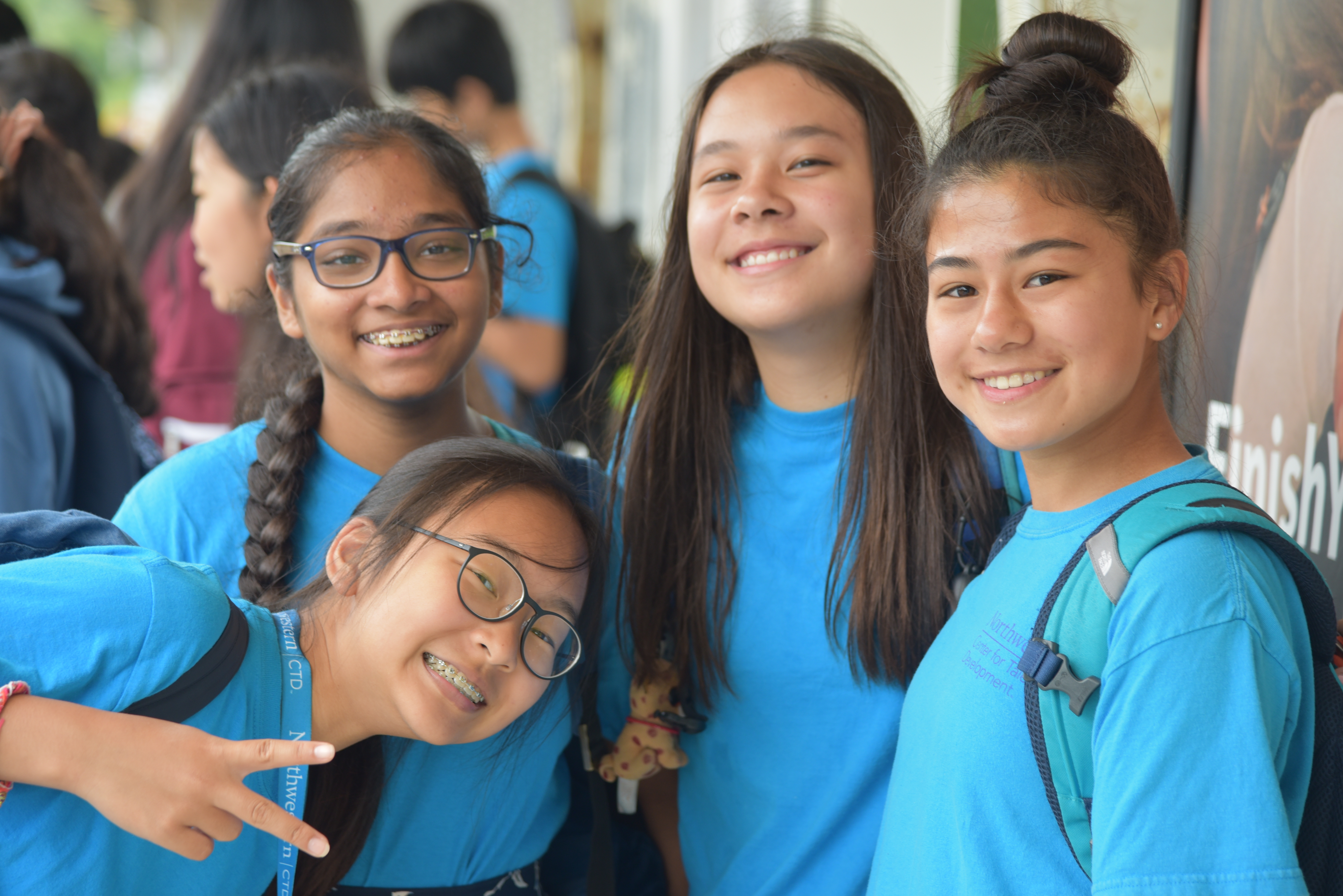 4 students blue shirts train