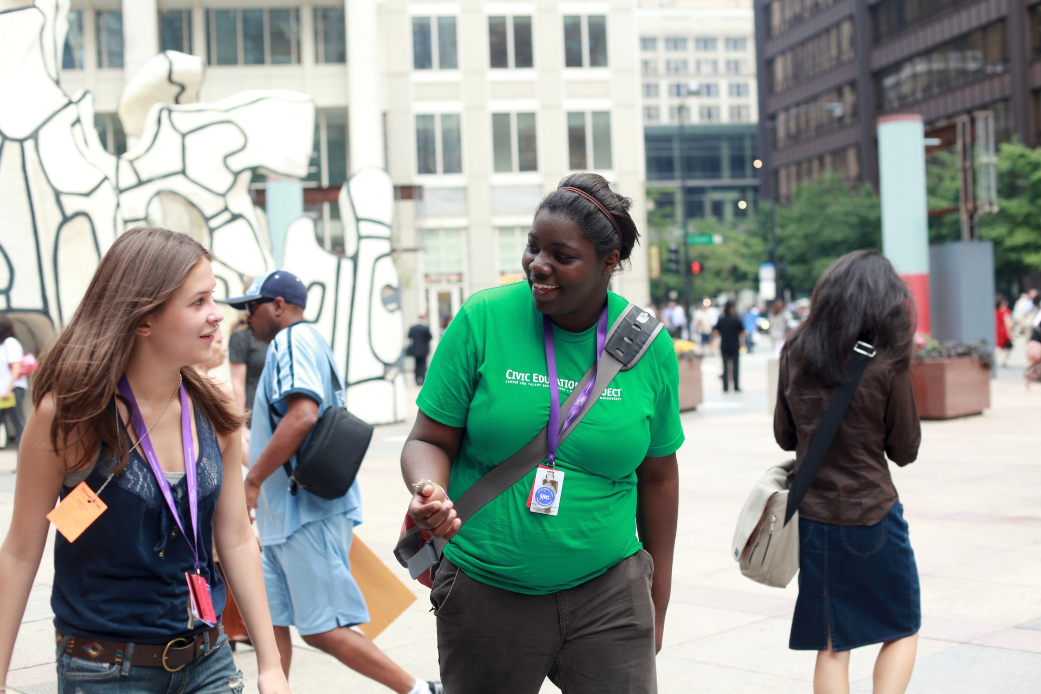 student and staff member walking