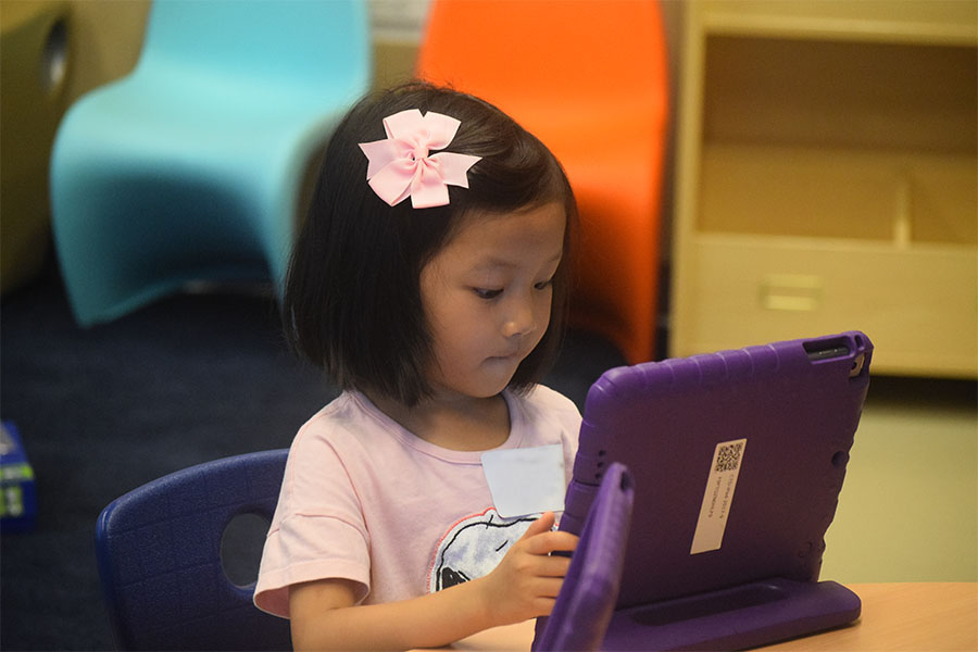 young girl working on ipad