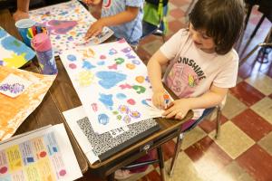 Young girl creating art using shapes