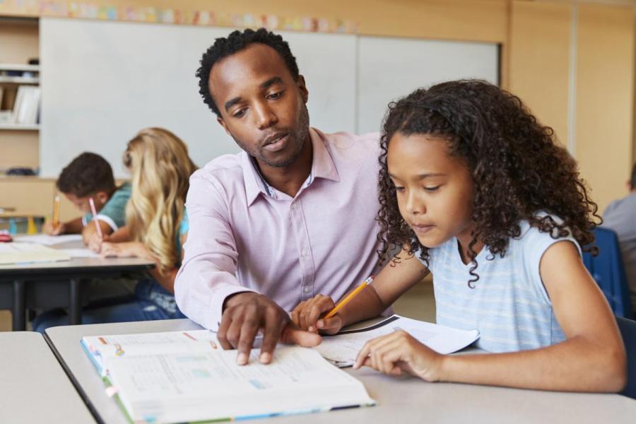 Teacher Helping Student with School Work 