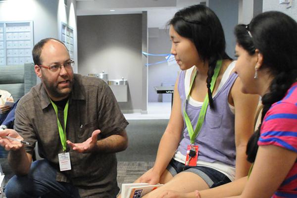 Teacher conversing with students