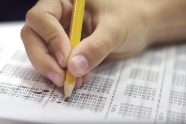 Hand of test-taker holding pencil