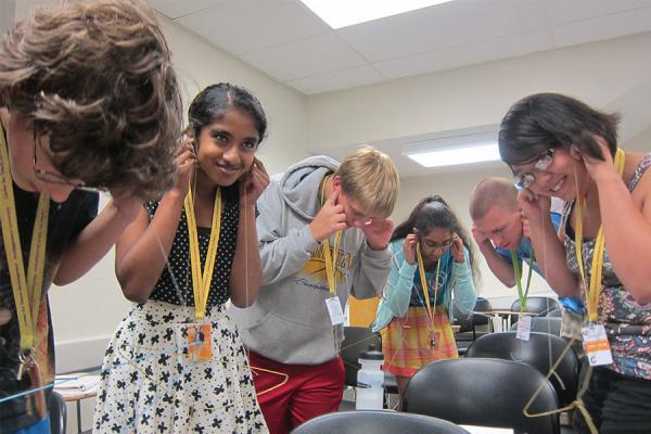 middle students doing experiment in physics class