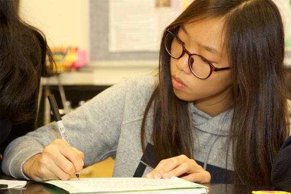 middle school girl writing in notebook