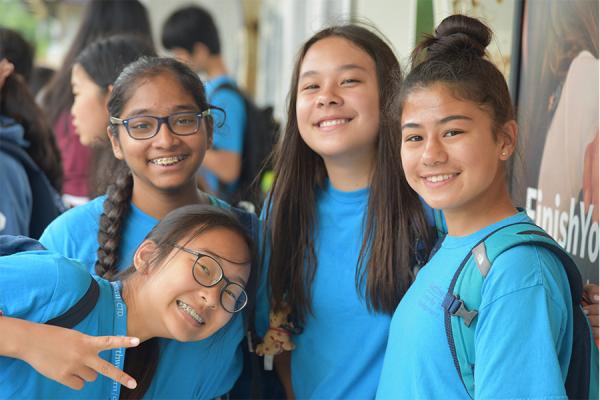 four middle school girls smiling for camera