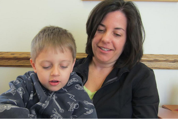 parent and child on a chair reading