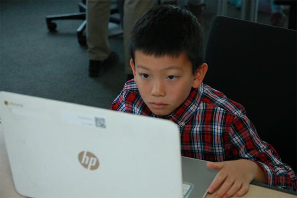 young boy working on laptop