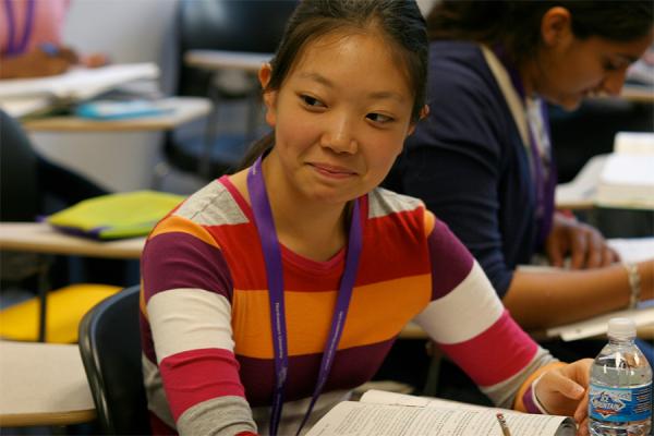 high school girl taking an assessment in a classroom