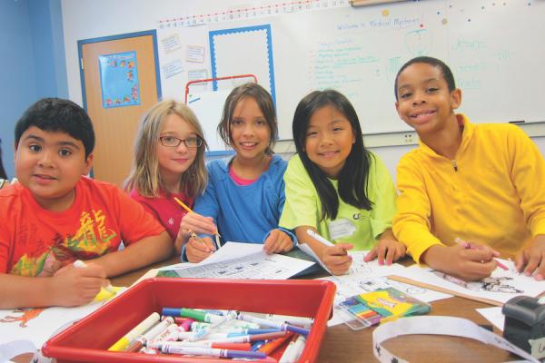 diverse group of elementary students working on a project 