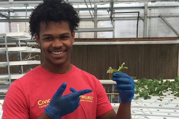 High school boy in community garden