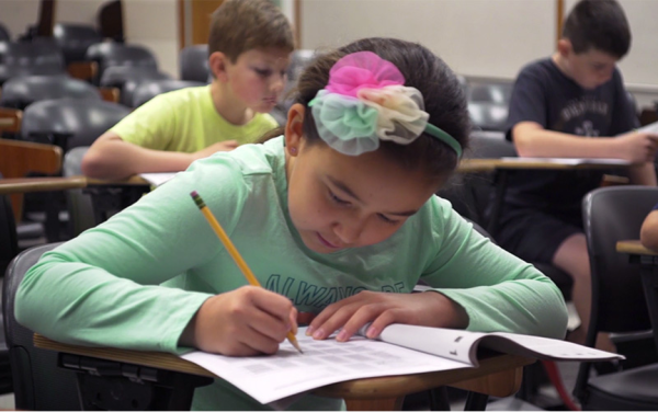 Young girl student taking a test 