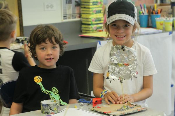 elementary girl and boy building models