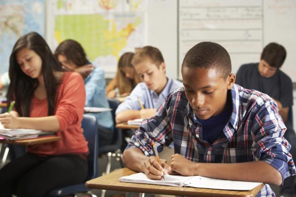 high school students taking a test in a classroom