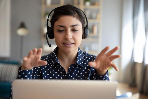 adult talking with headset at computer